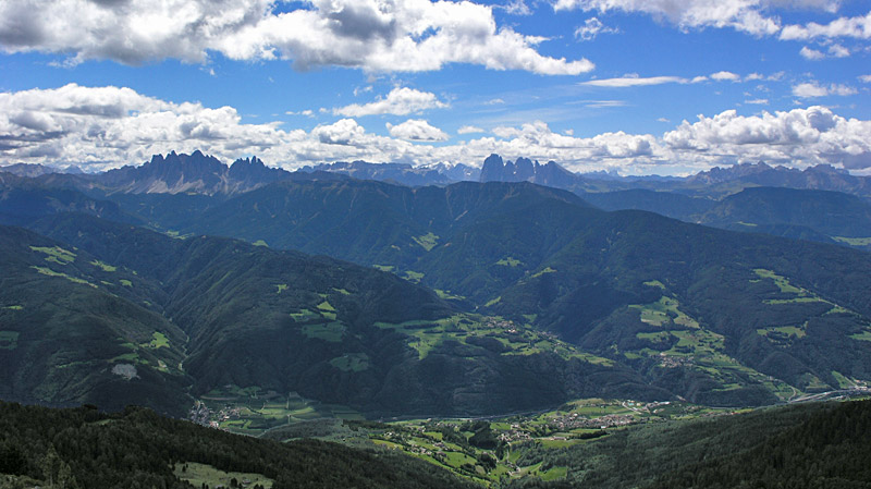 Het uitzicht is mooi. Op de voorgrond Feldthurns in het Eisacktal. In de verte de Dolomieten met links de Geislergruppe, in het midden het Sellamasief, de Langkofel, Plattkofel en Marmolada en rechts de Schlern.